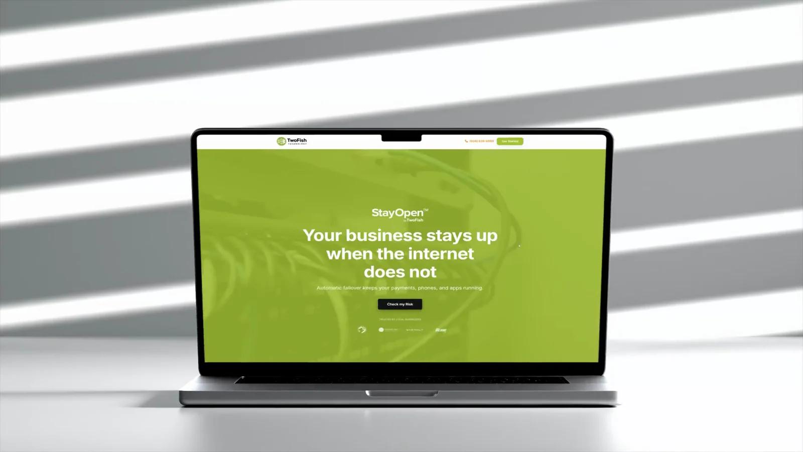 Two Fish Technology website shown on a laptop.