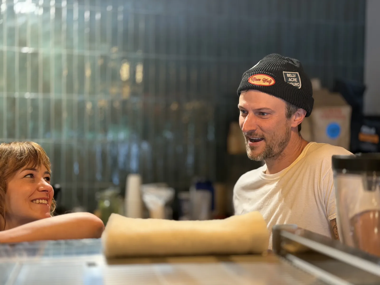 A customer talking with Richie Conry behind the Moon Wolf bar during an operator field visit.